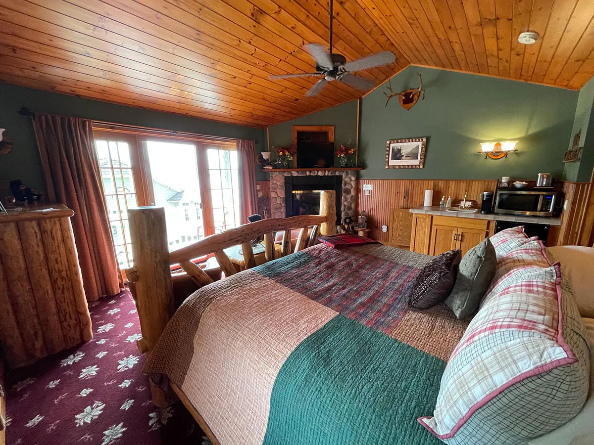Mason’s Adirondack Suite four post bed and fireplace
